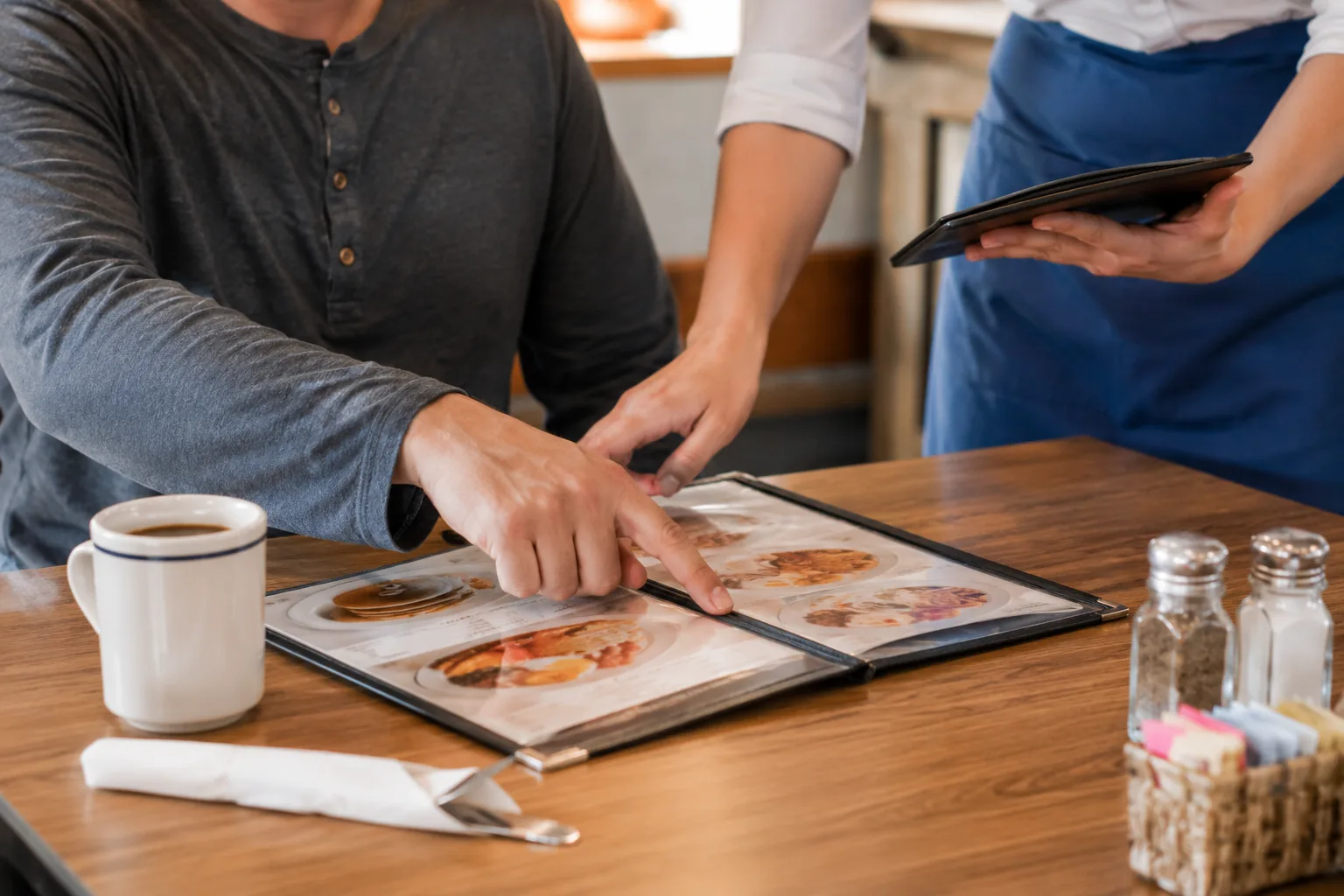 Guest discussing a custom order with a server, related to ordering IHOP secret menu items