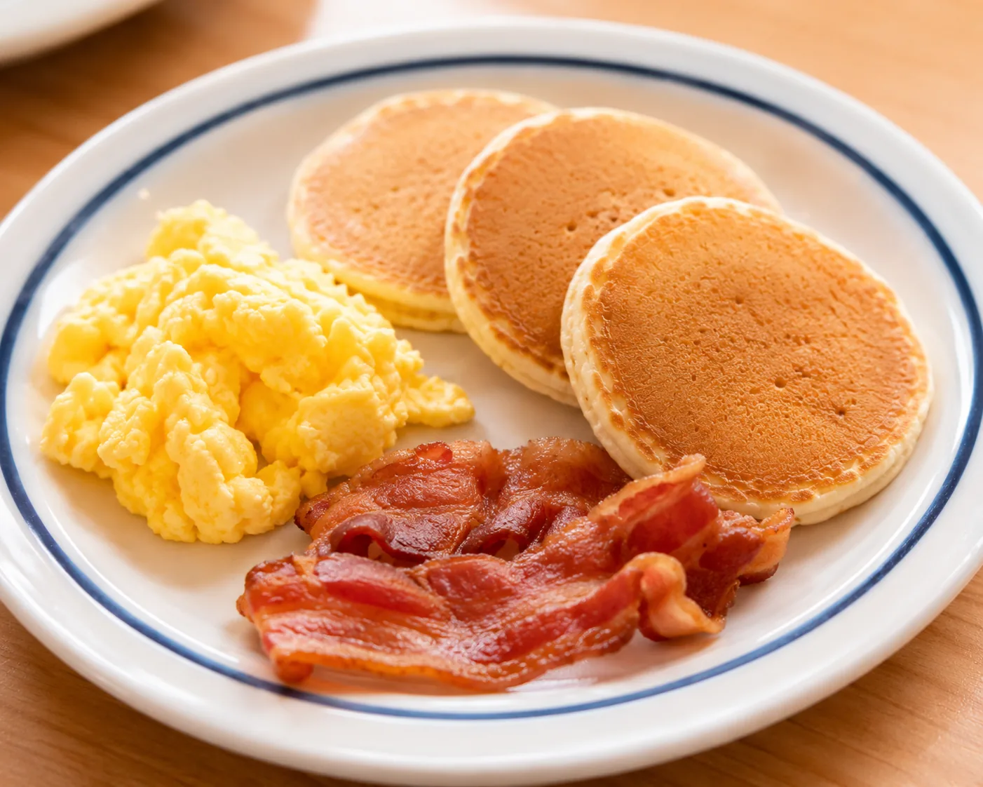 Kids breakfast plate with mini pancakes and eggs, related to IHOP kids eat free deal