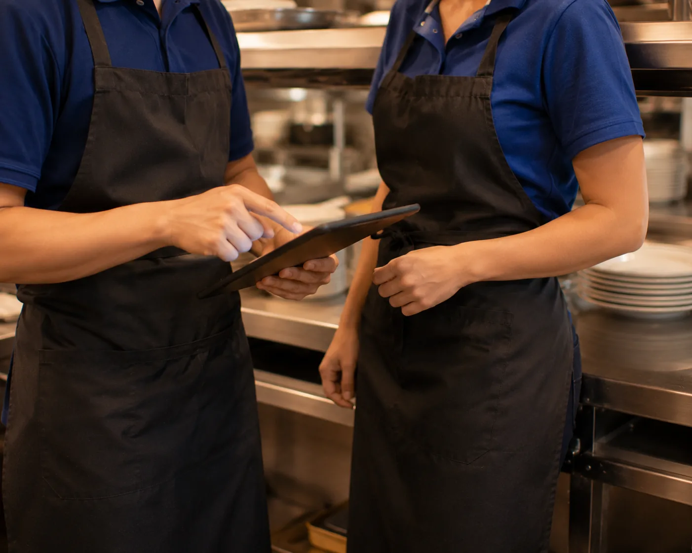 Two restaurant staff reviewing information together, related to career growth at IHOP