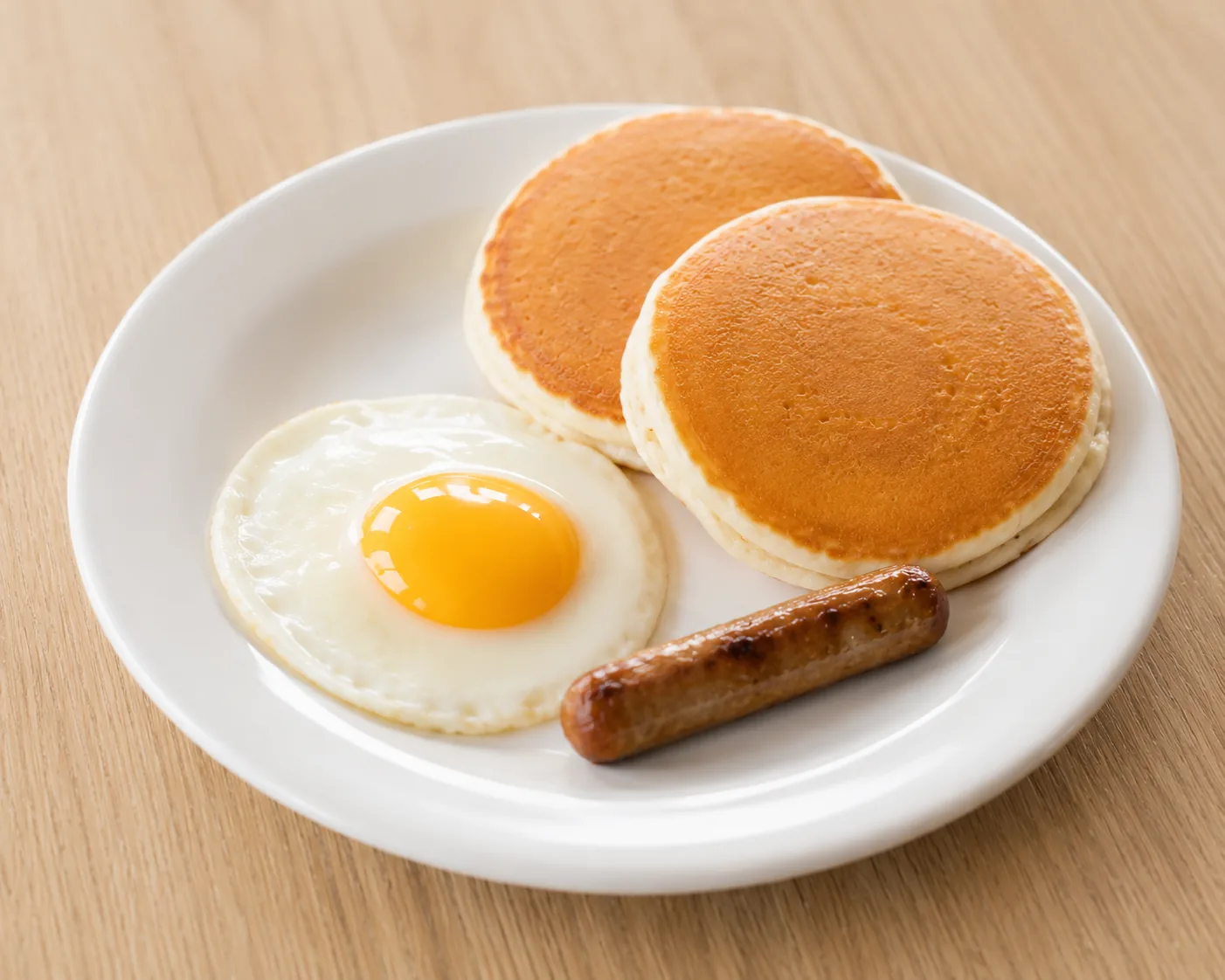 Small breakfast plate with pancakes and eggs, related to IHOP value menu prices
