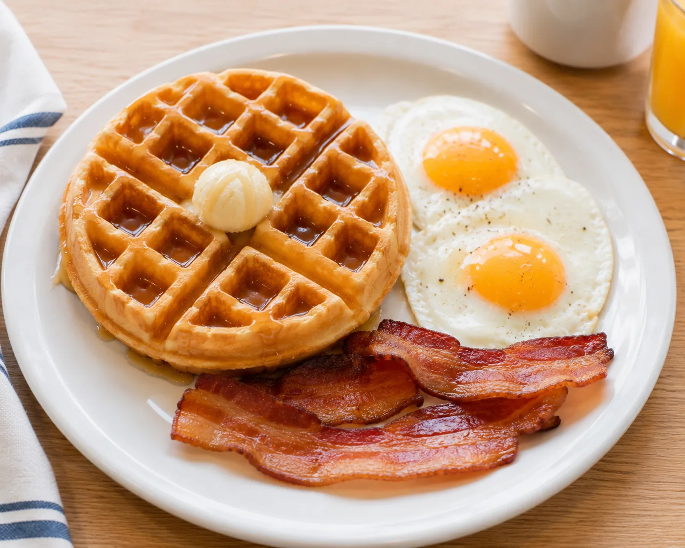 Waffle combo plate with eggs and bacon, related to IHOP's waffle menu options