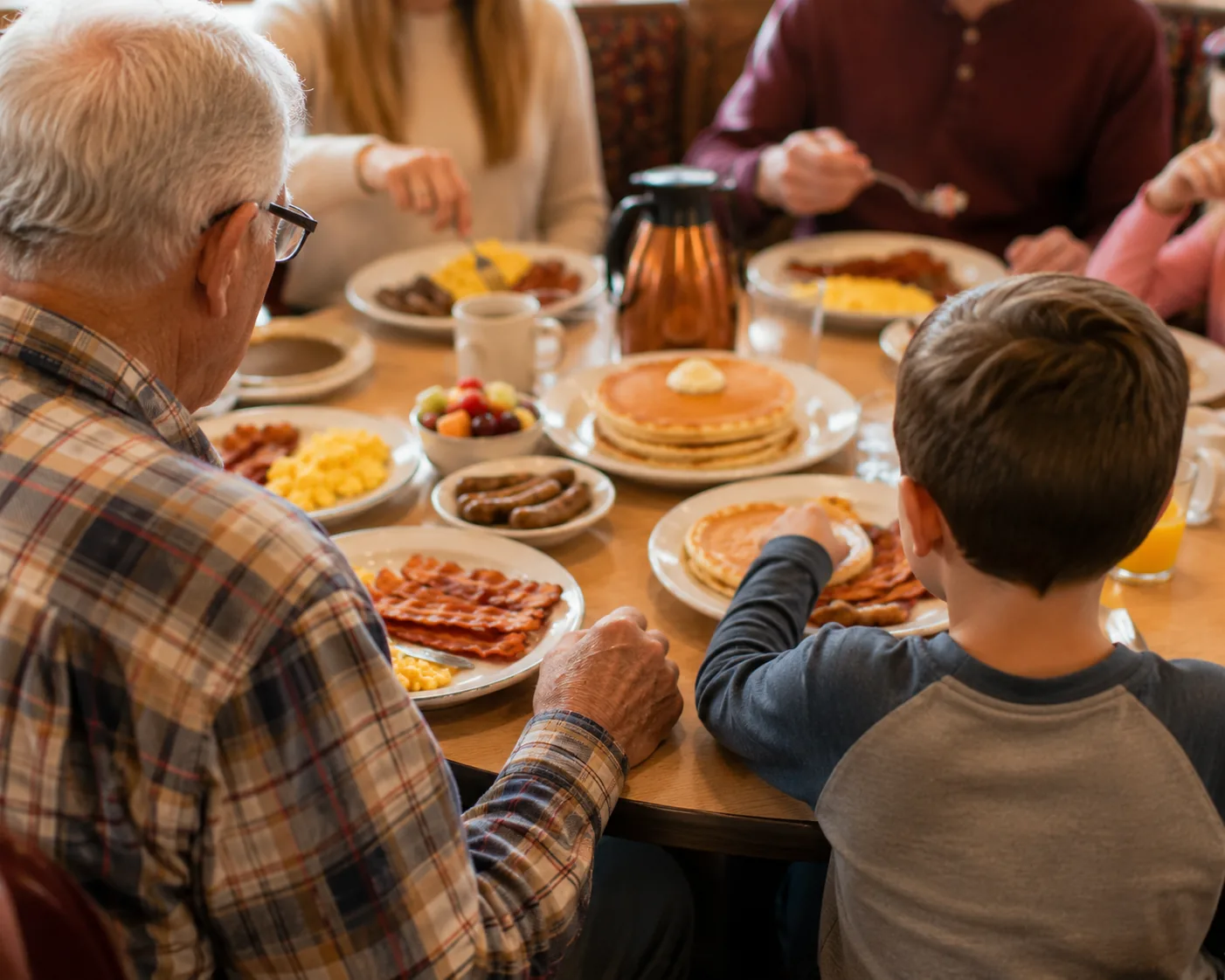 Multi-generation family sharing breakfast, related to IHOP's Family Feast for groups