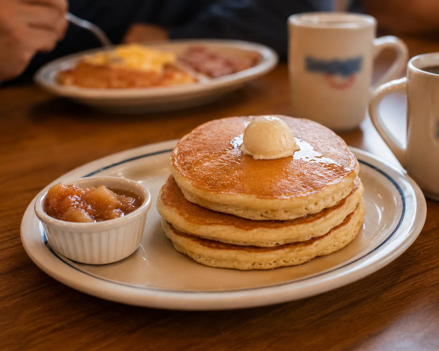 Pancake stack with a ramekin of apple butter, related to tips for the best pancake experience