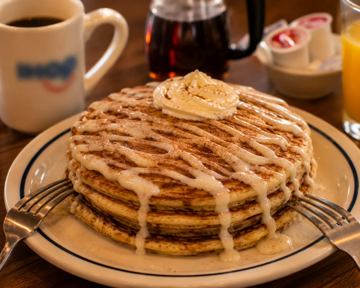 Shared pancake dish with two forks, related to splitting a rich pancake order at IHOP